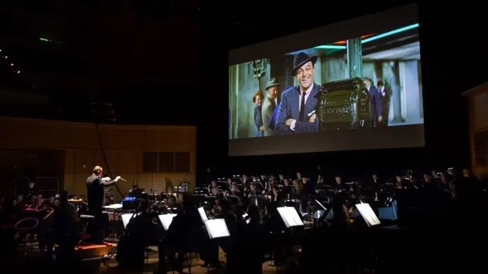 Neil Thomson conducting the orchestra during Gene Kelly: A Life in Music
